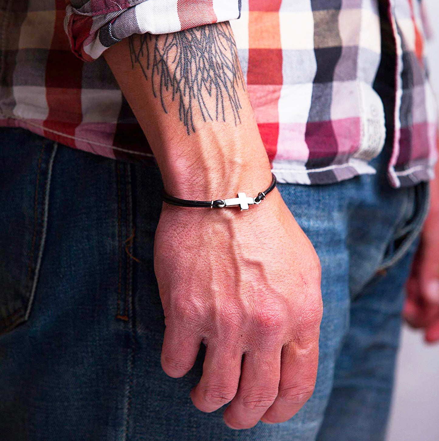 Christian leather bracelet with cross worn on wrist – faith-based men’s gift with rustic style