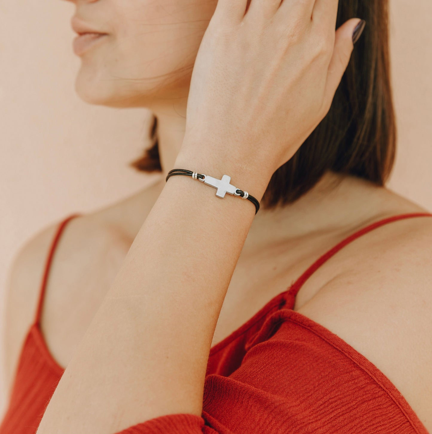 Woman wearing Christian cross bracelet – minimalist faith bracelet for women
