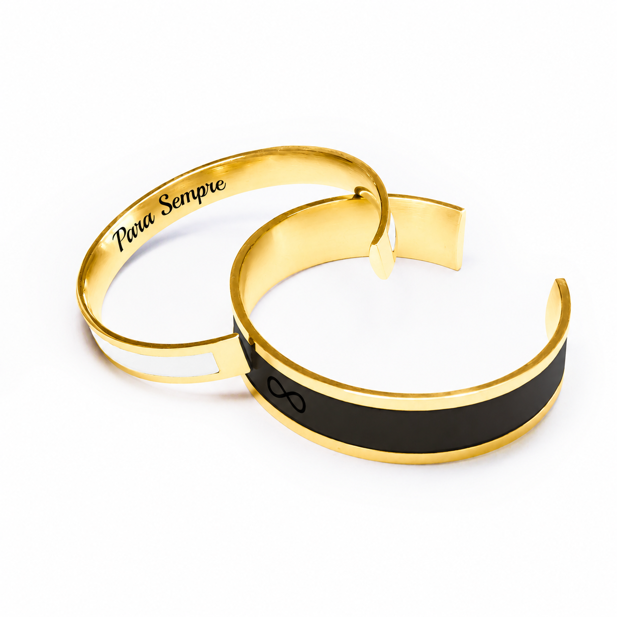 A photo of two matching bracelets, one in gold color and the other in black, with the word 'amor' and a heart symbol engraved on the gold bracelet.